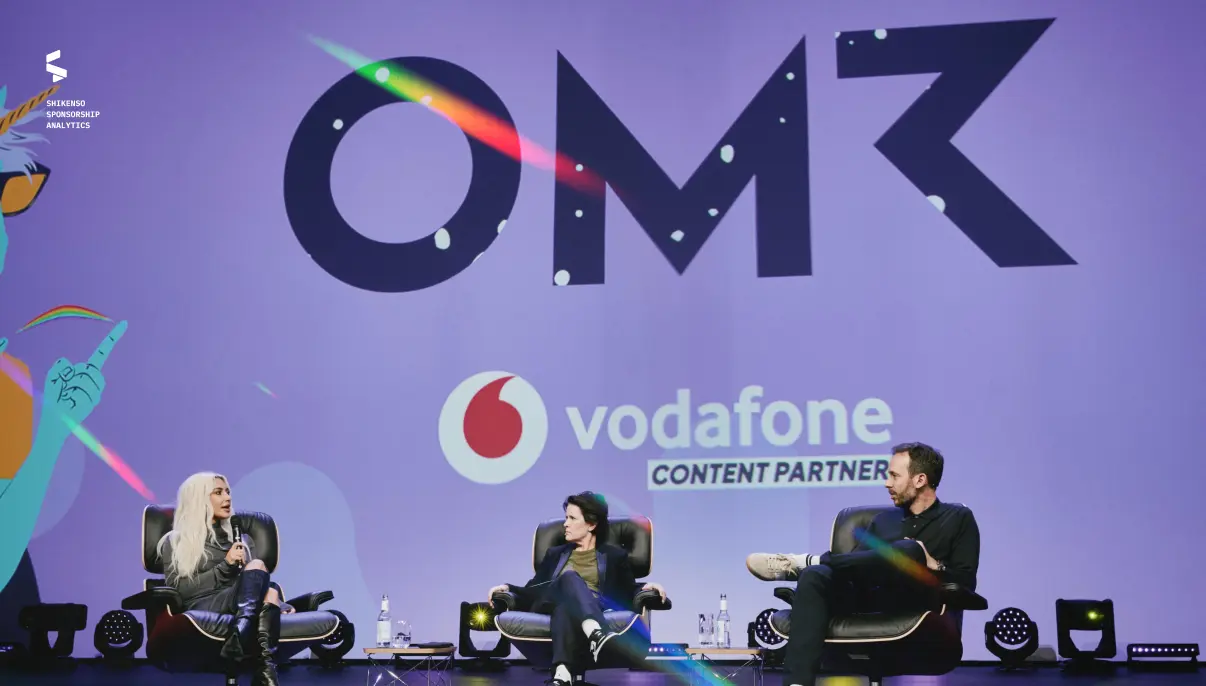 People seated on stage at OMR with Vodafone as content partner, discussing topics in front of large event backdrop and branding.